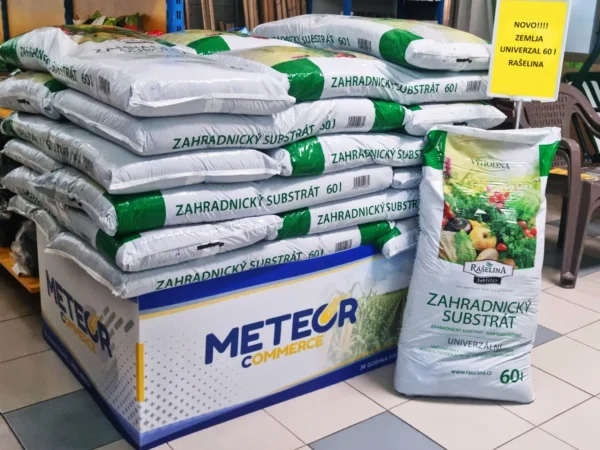 Bag of quality universal growing medium beside young vegetable and flower seedlings in a greenhouse – Rašelina, in our range